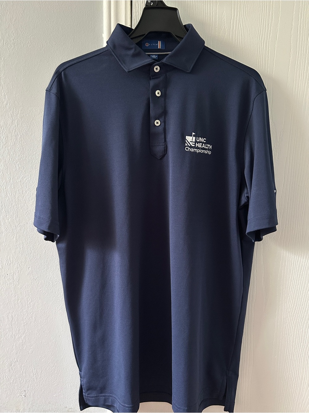 Men's Navy Polo with UNC Health Championship Logo